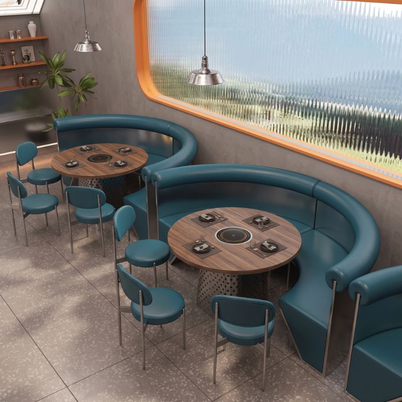 Round hot pot table with curved booth seating for commercial dining spaces